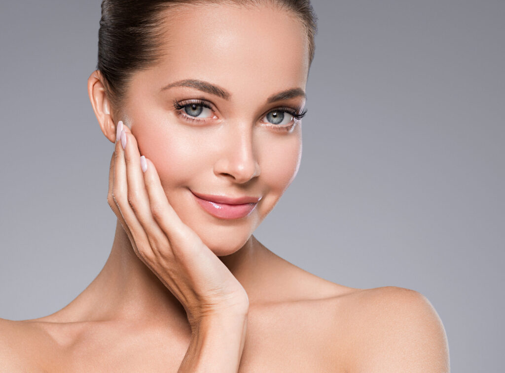 Smiling woman with glowing skin enjoys wellness and relaxation at Just Breathe by Jodi spa in Cave Creek, AZ.